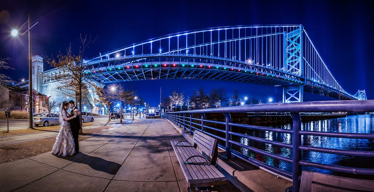 Wedding couple at night by the Ben Franklin Bridge